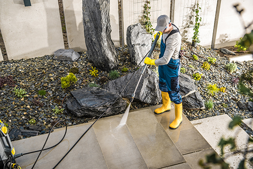 Shore Powerwashing Pro employee performing Beachwood power washing on a walkway