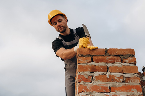 Mantoloking chimney service repairman working on mortar and brick chimney